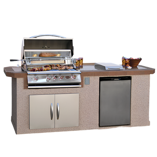 Outdoor kitchen with grill, cabinets, and refrigerator on a white background